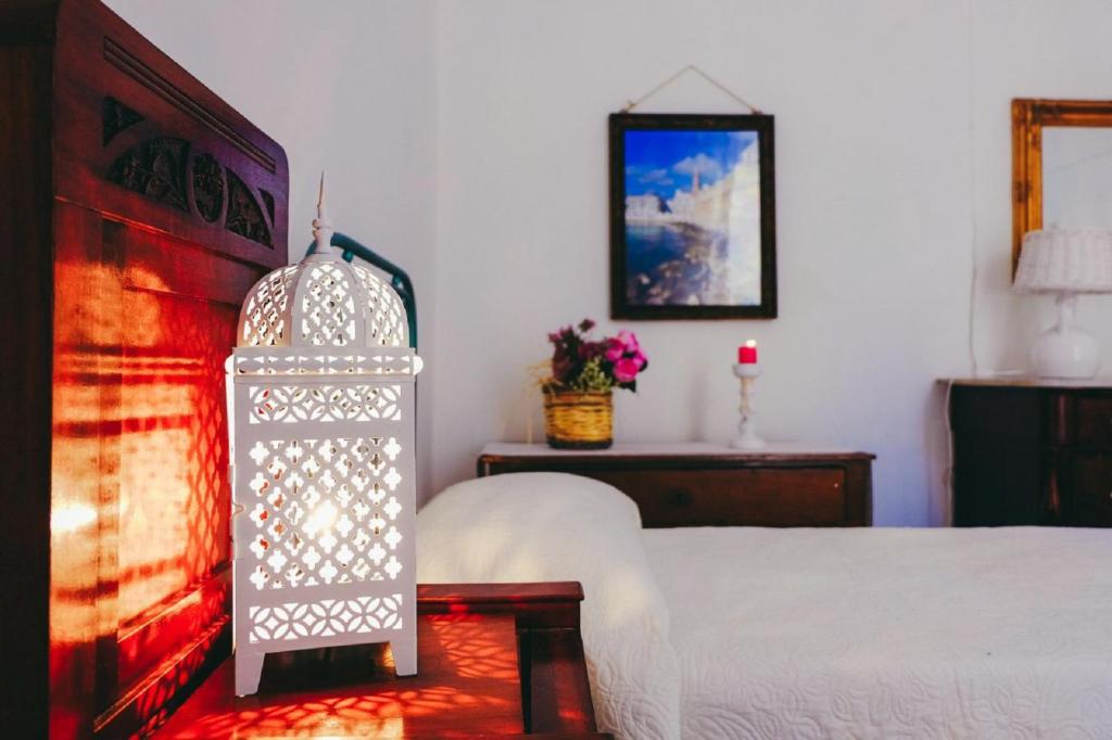 a bedroom with a bed and a table with a lamp at Dimora Storica Monopoli in Monopoli