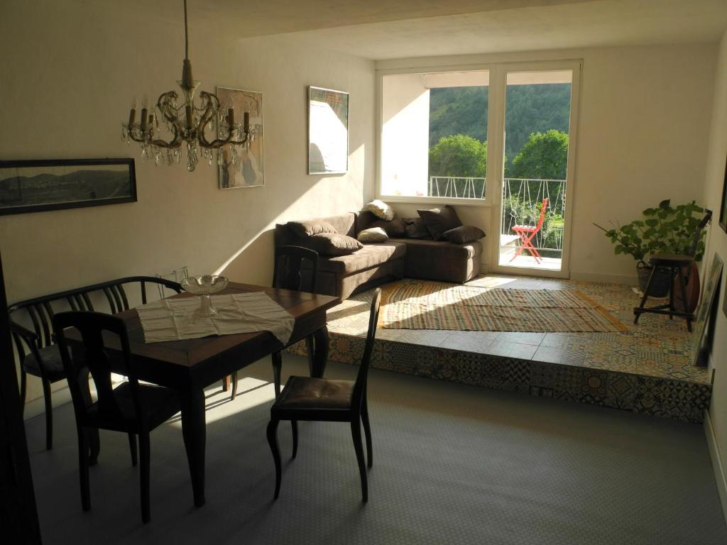 a living room with a table and chairs and a couch at Apartment Lollo in Enkirch