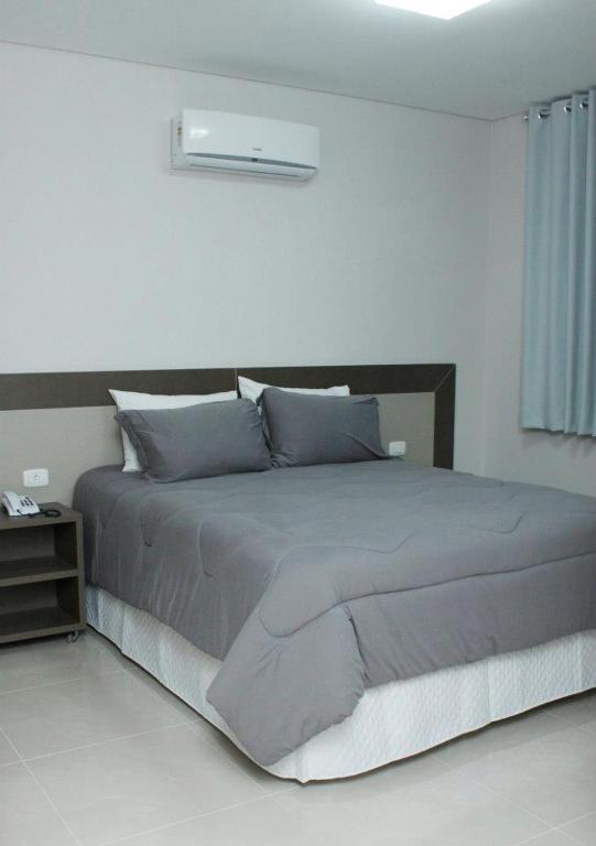 Postel nebo postele na pokoji v ubytování Hotel Cadori