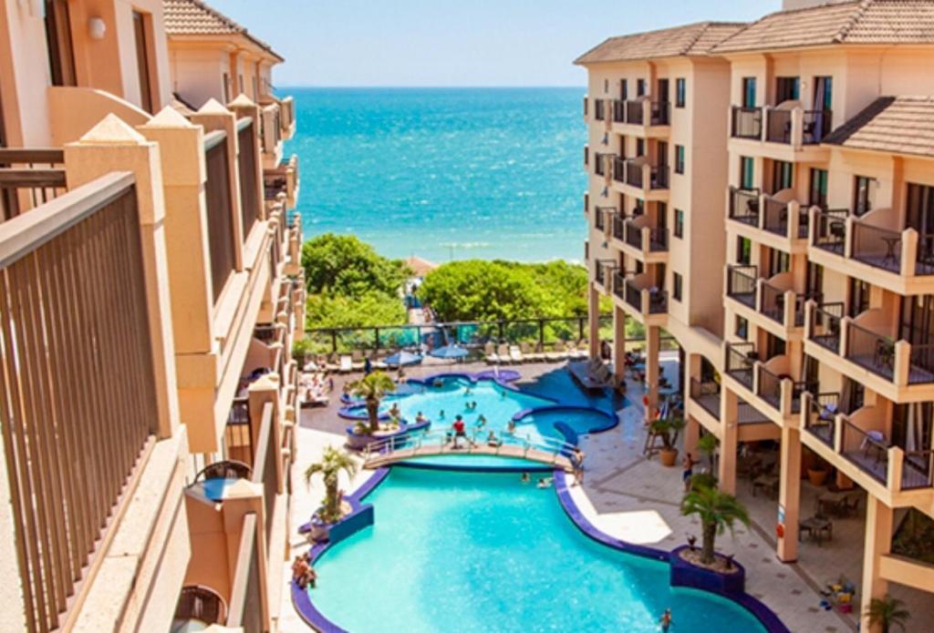 a view of the pool from the balcony of a resort at Flat Partic Hotel Jurere Beach Village in Florianópolis