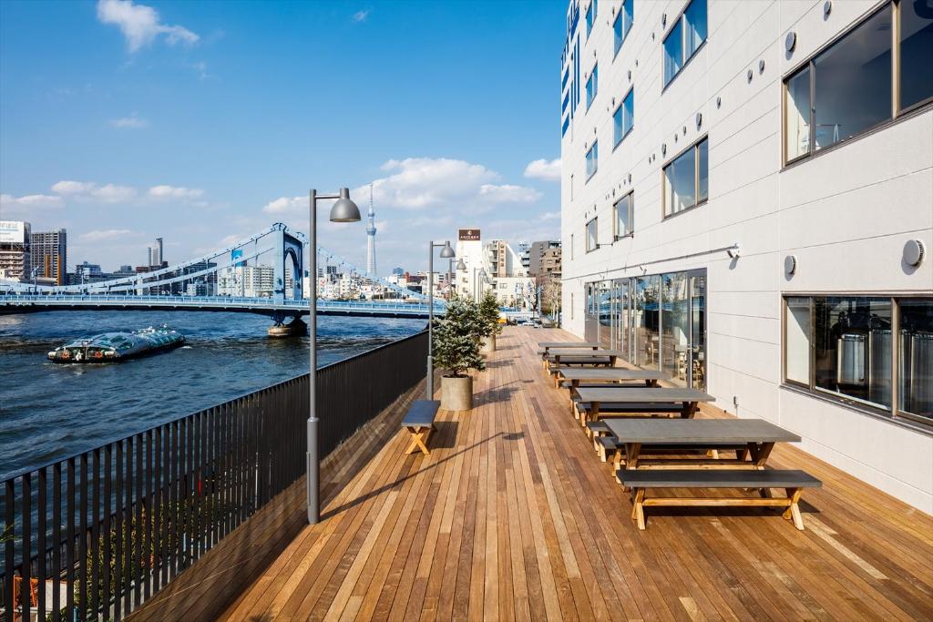 a row of benches on the side of a building at The Share Hotels Lyuro Tokyo Kiyosumi in Tokyo