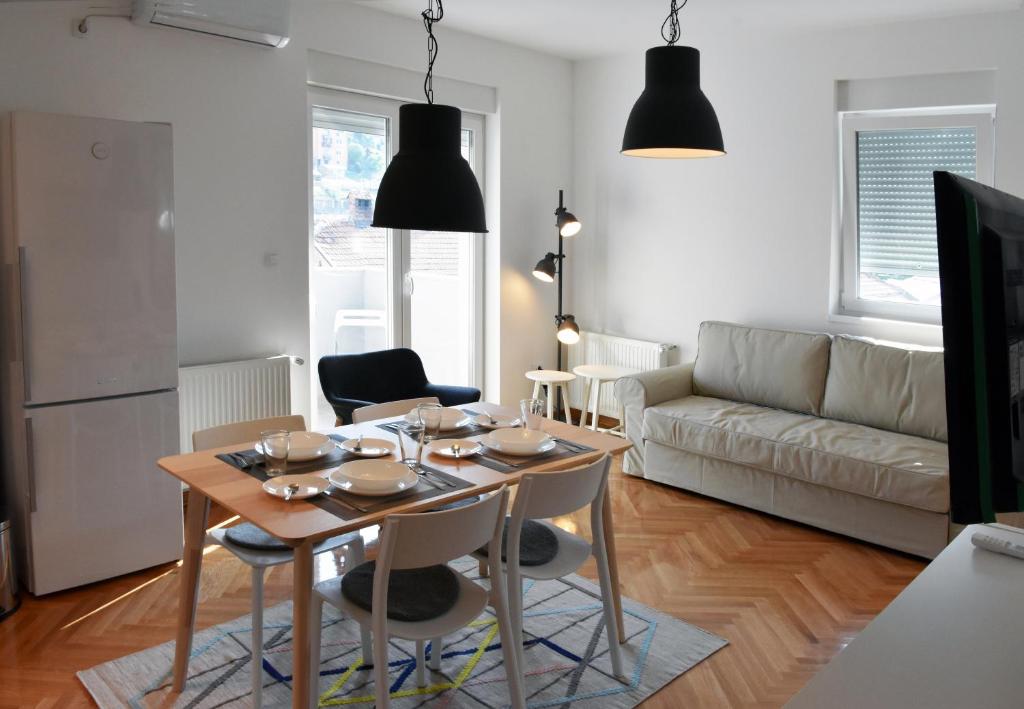 a living room with a table and a couch at Apartment Exclusive in Užice