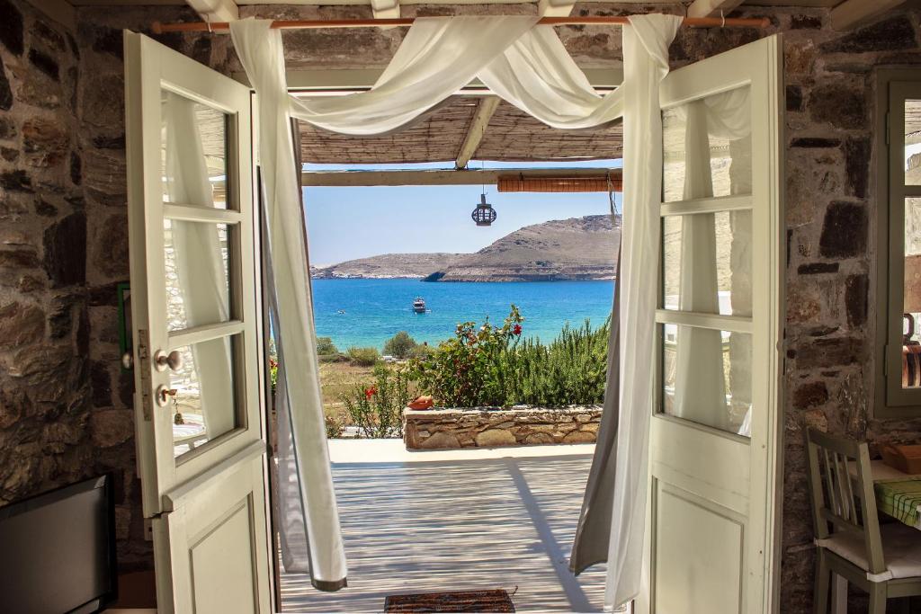 an open door with a view of the ocean at Serifos Dream Houses near the sea in Ganema