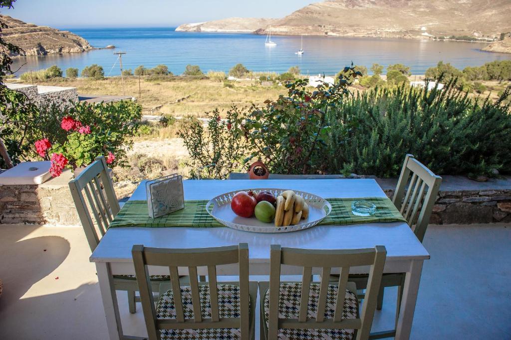 a table with a plate of fruit on top of it at Serifos Dream Houses near the sea in Ganema