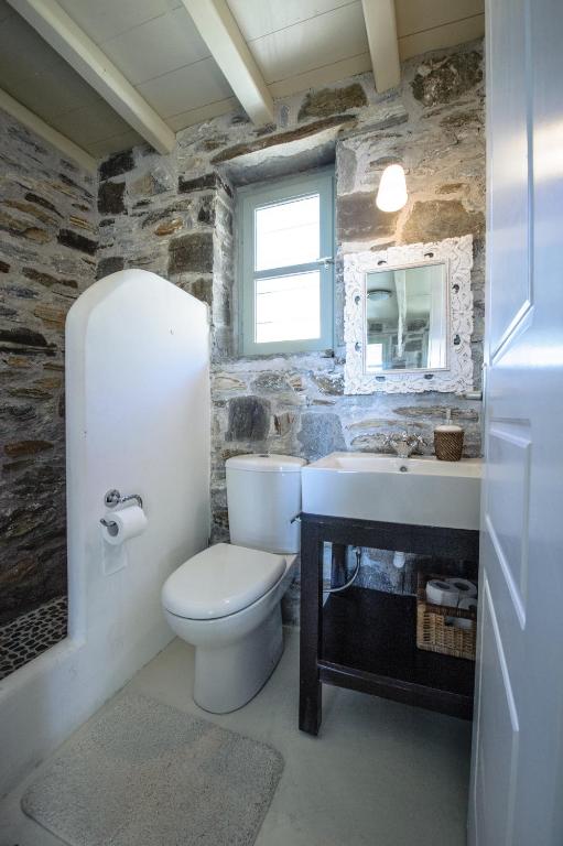 a bathroom with a toilet and a sink at Serifos Dream Houses near the sea in Ganema