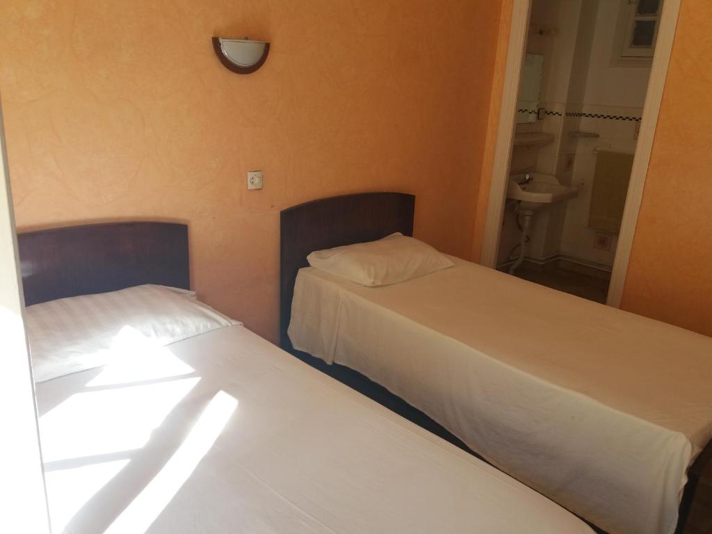 Letto o letti in una camera di Hotel Le Gardenia (ex Lutetia)