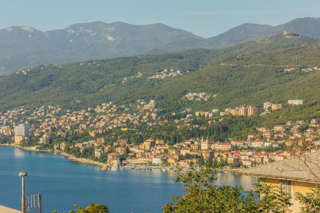 a view of a town on a river with mountains at Apartments Villa Luciana in Rijeka