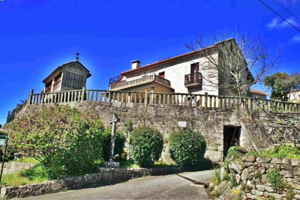 a house on top of a stone wall at Casa Combarro in Combarro