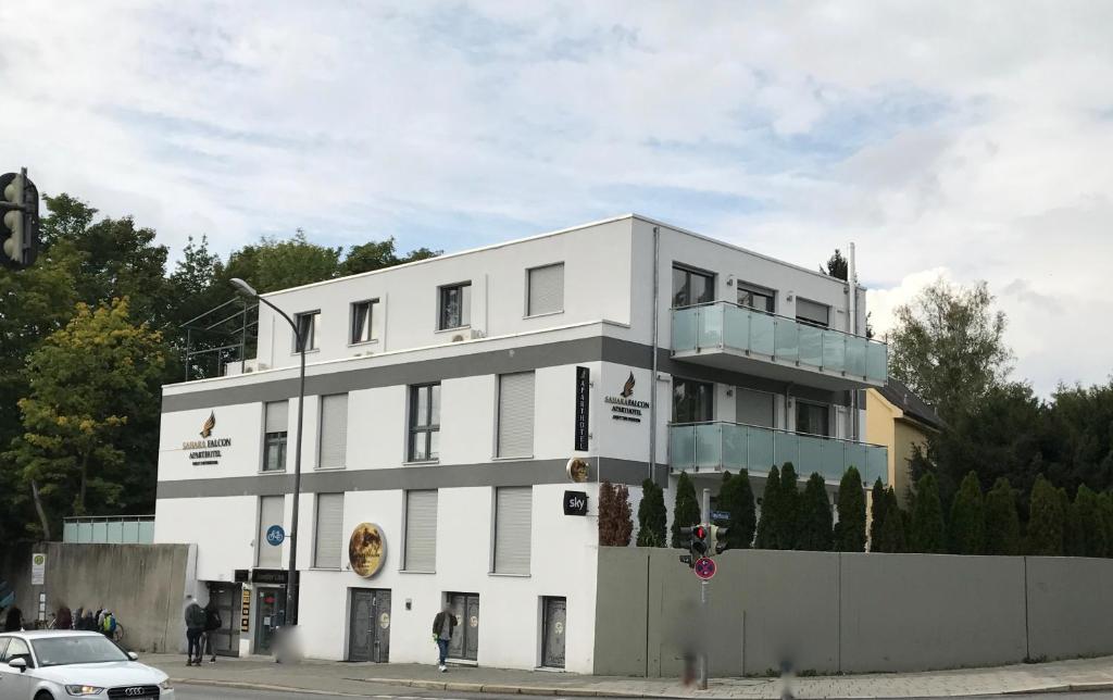 a white building on the corner of a street at Sahara Falcon in Munich