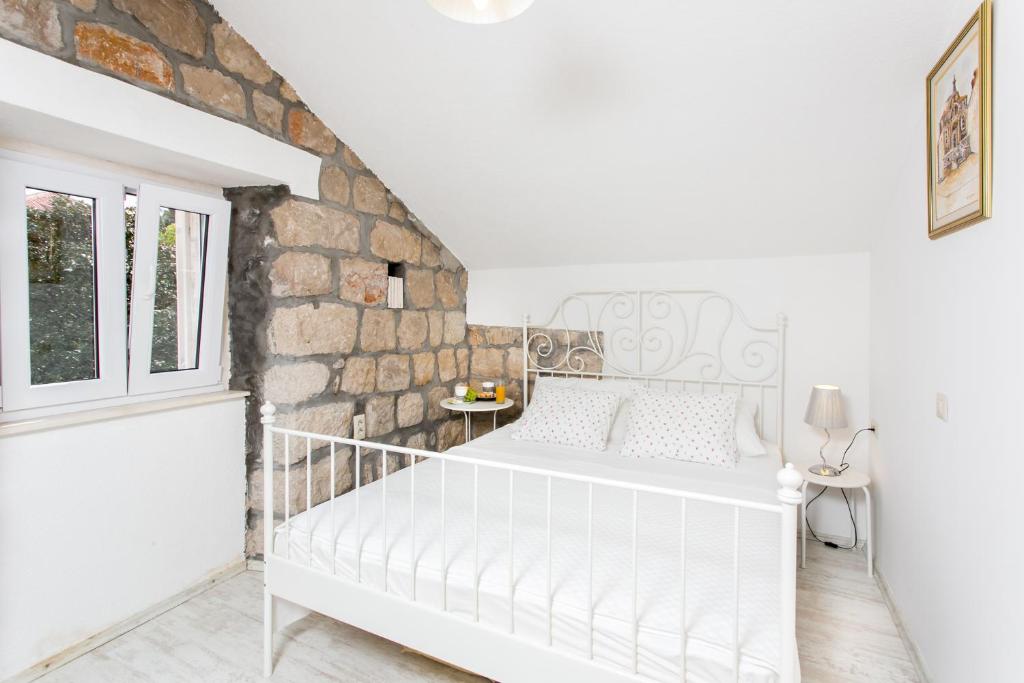 Postel nebo postele na pokoji v ubytování Apartments Heart of Dubrovnik