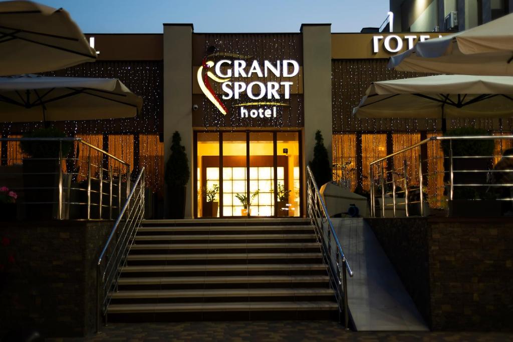 a grand sport hotel with stairs leading to the front door at Grand Sport Hotel in Brovary
