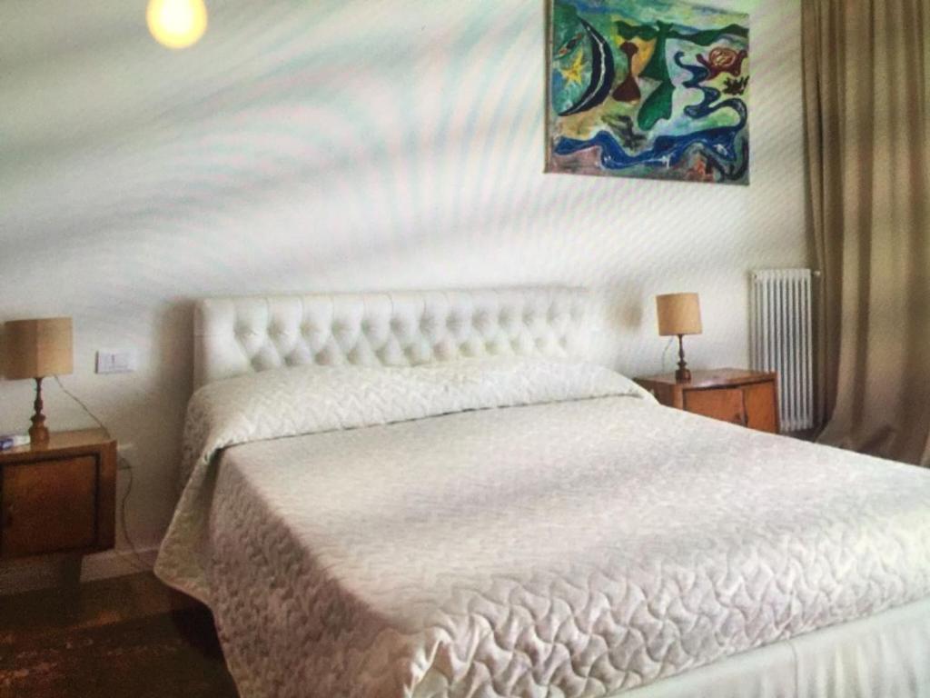 Łóżko lub łóżka w pokoju w obiekcie Casa con giardino