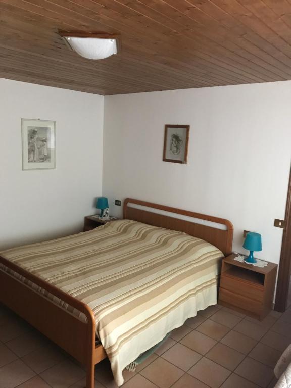 a bedroom with a bed and a wooden ceiling at Residence Riccardi in San Marino