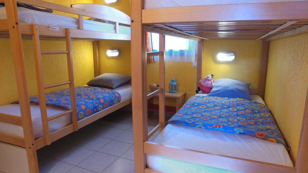 a bedroom with two bunk beds and a room with a bed at VVF Sud Vercors in Die