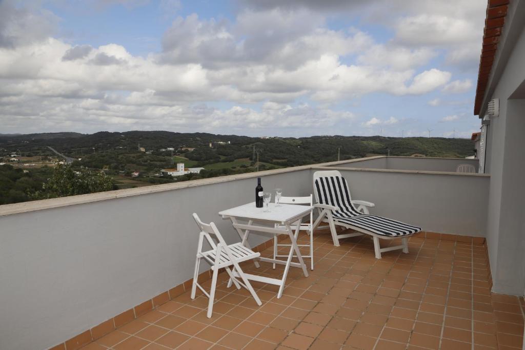 a balcony with a table and chairs on a roof at Llucmajor 29 in Mahón
