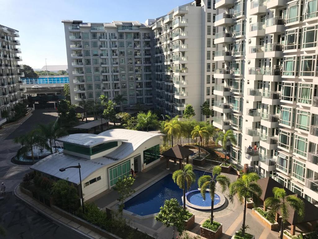 an aerial view of a building with palm trees and buildings at Aurora's Home in Manila