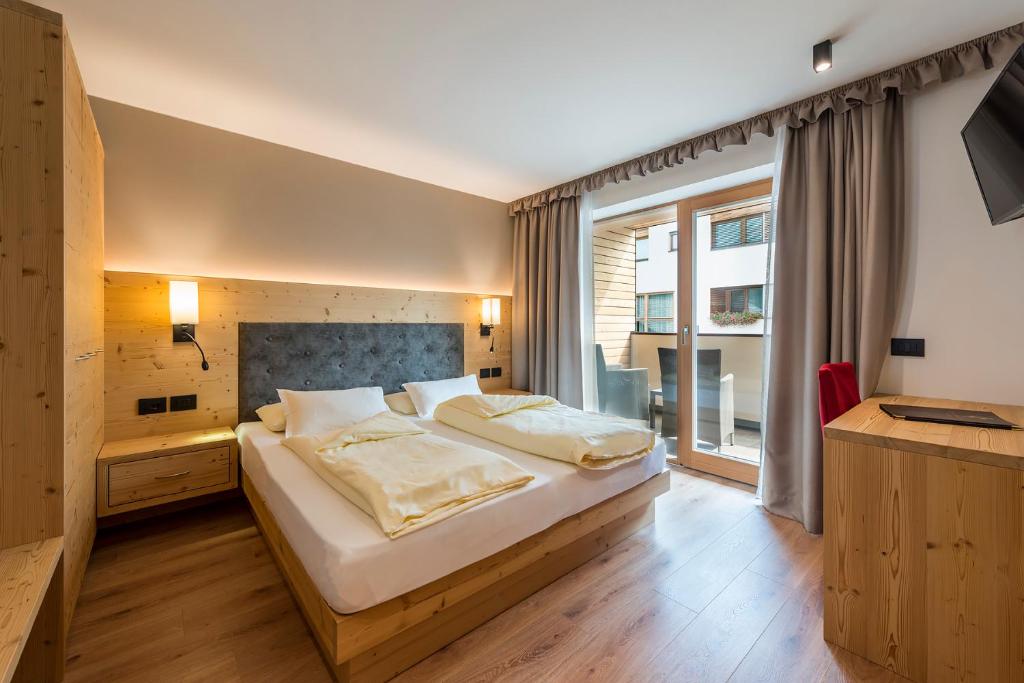 Posteľ alebo postele v izbe v ubytovaní Hotel Cavallino