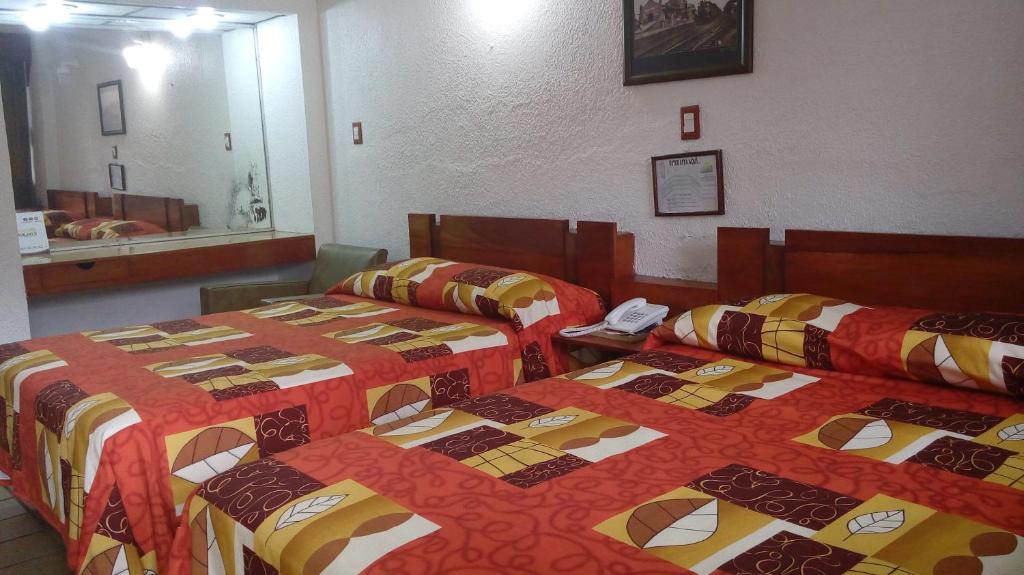 Postel nebo postele na pokoji v ubytování Hotel Cabildos