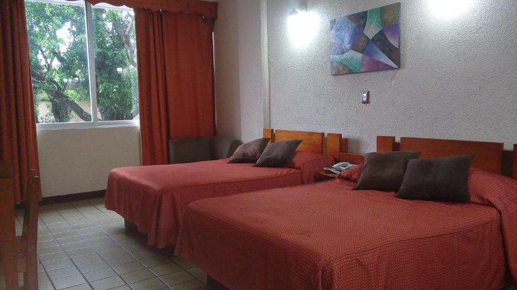 Postel nebo postele na pokoji v ubytování Hotel Cabildos