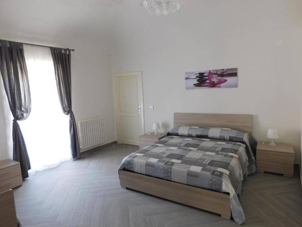 Postel nebo postele na pokoji v ubytování Palazzo dei Vespri
