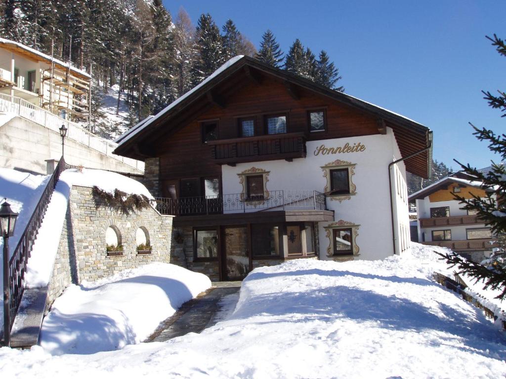 a large building with snow in front of it at Haus Sonnleite in Trins