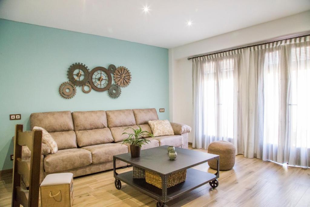a living room with a couch and a table at Apartament Rural El Rellotge in Sant Mateu