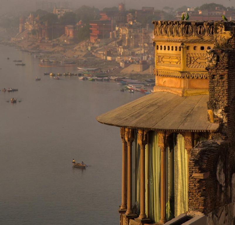 a large building with a boat on top of it at Brijrama Palace, Varanasi - Heritage boutique hotel by the Ganges in Varanasi