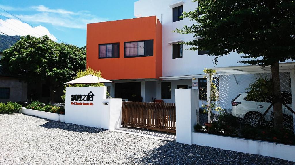 an orange and white building with a fence at 26-2 Simple Home Life in Yuli