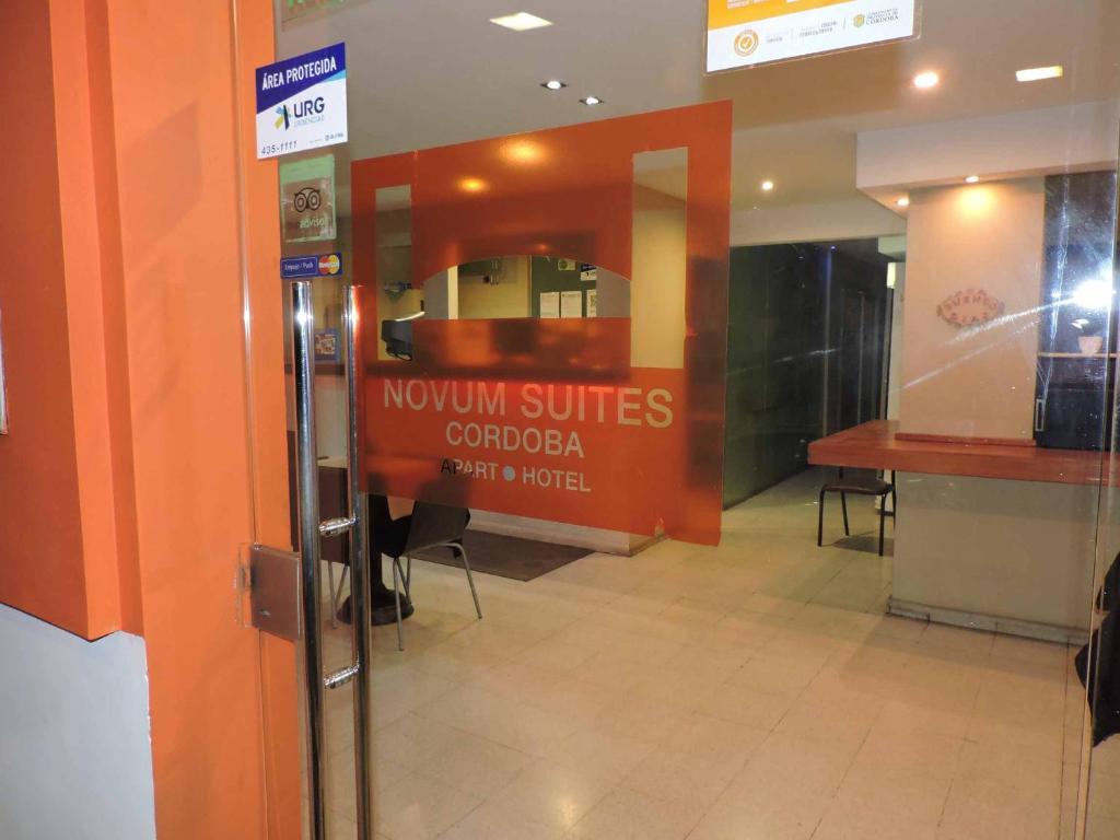 an entrance to a restaurant with a sign on a window at Novum Suites in Cordoba