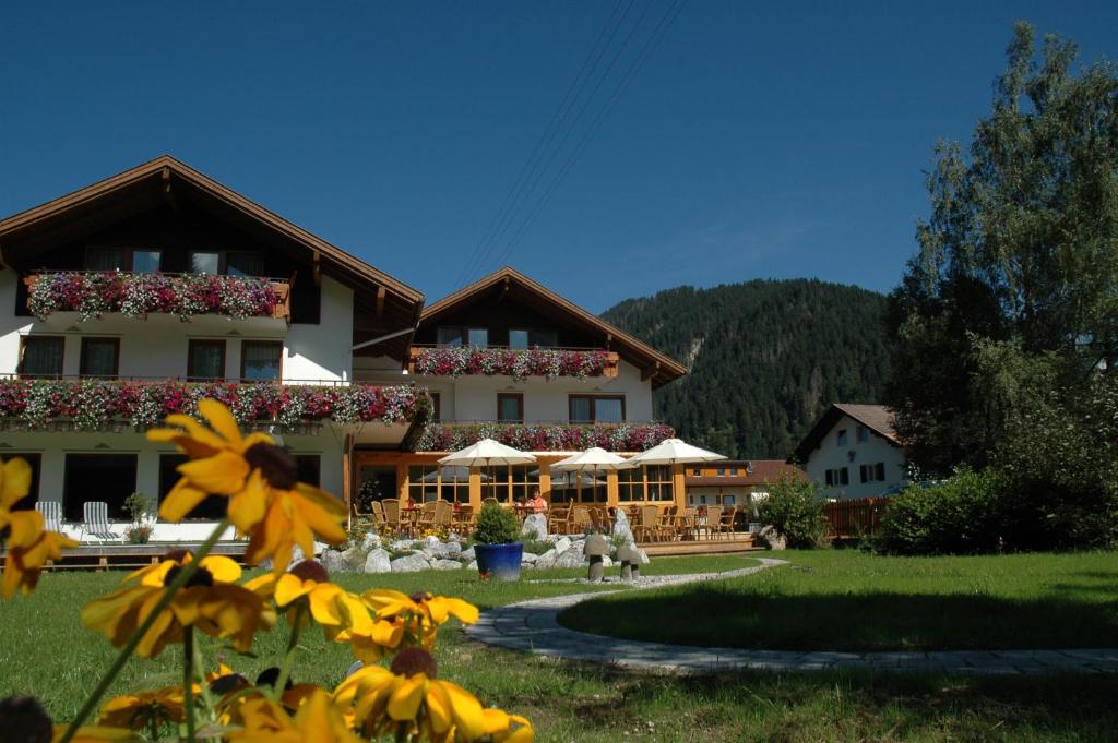 a large building with flowers in front of it at Hotel Anneliese in Bad Hindelang