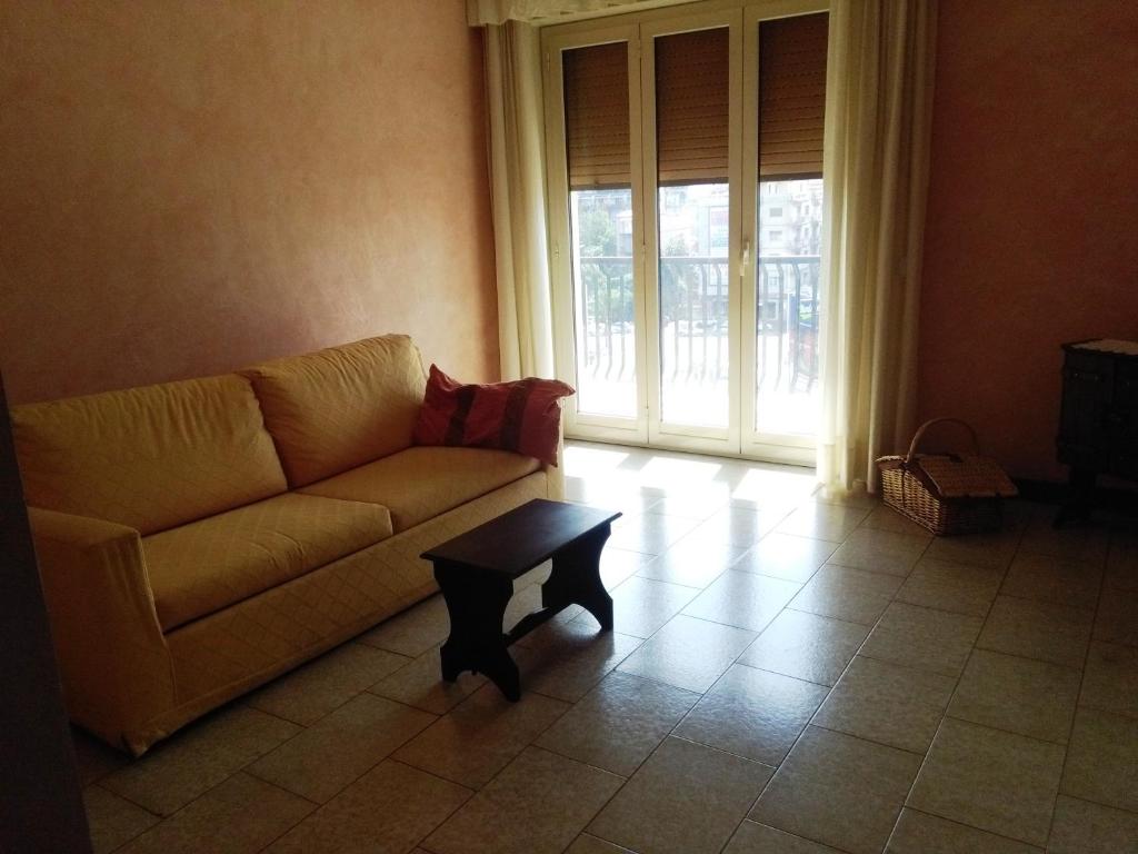 een woonkamer met een bank en een salontafel bij Letizia's House in Catania