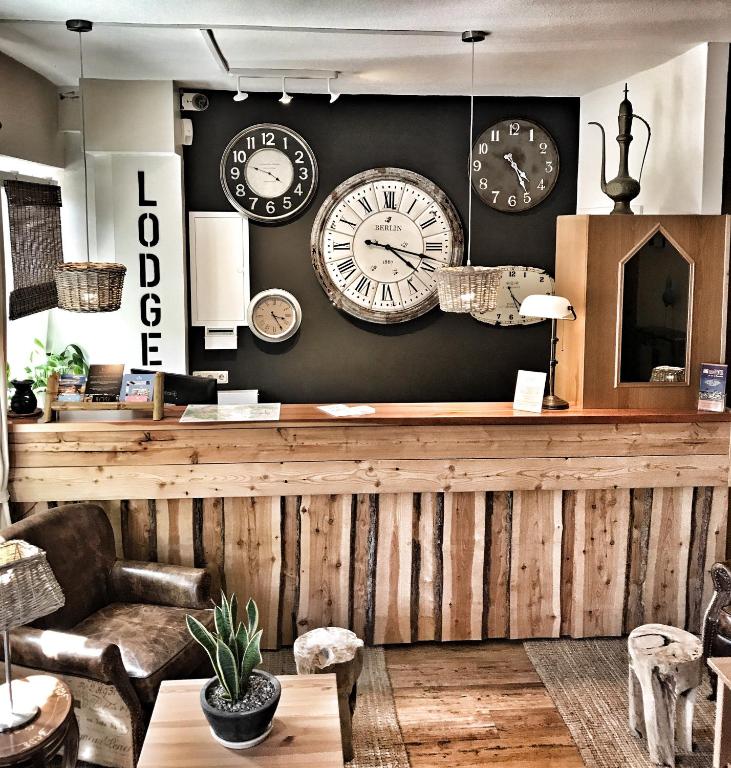a room with many clocks on the wall at Lodge Hotel Heiligendamm- digitales & rezeptionsloses Hotel in Heiligendamm