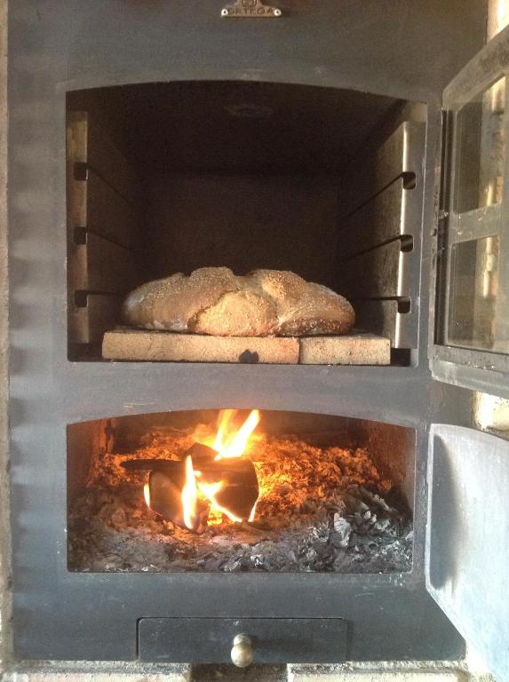a loaf of bread is cooking in an oven at Casa Rural Runa in Miranda de Arga