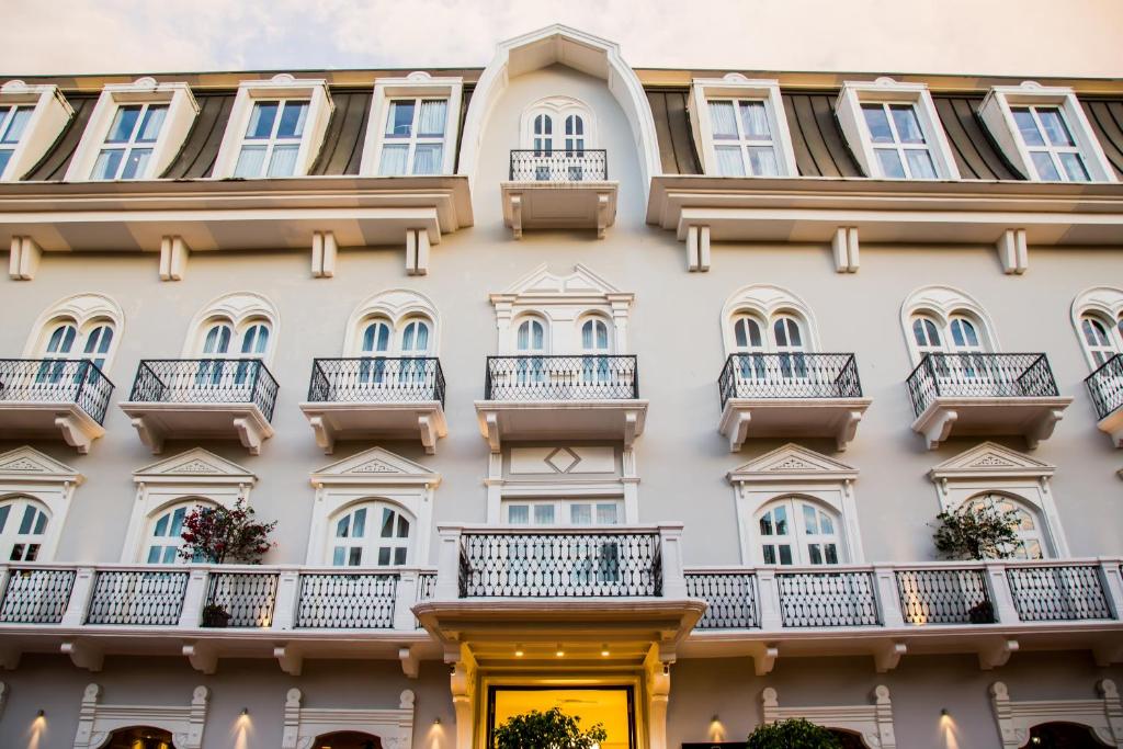 a building with balconies and a yellow door at Central Hotel Panama Casco Viejo in Panama City