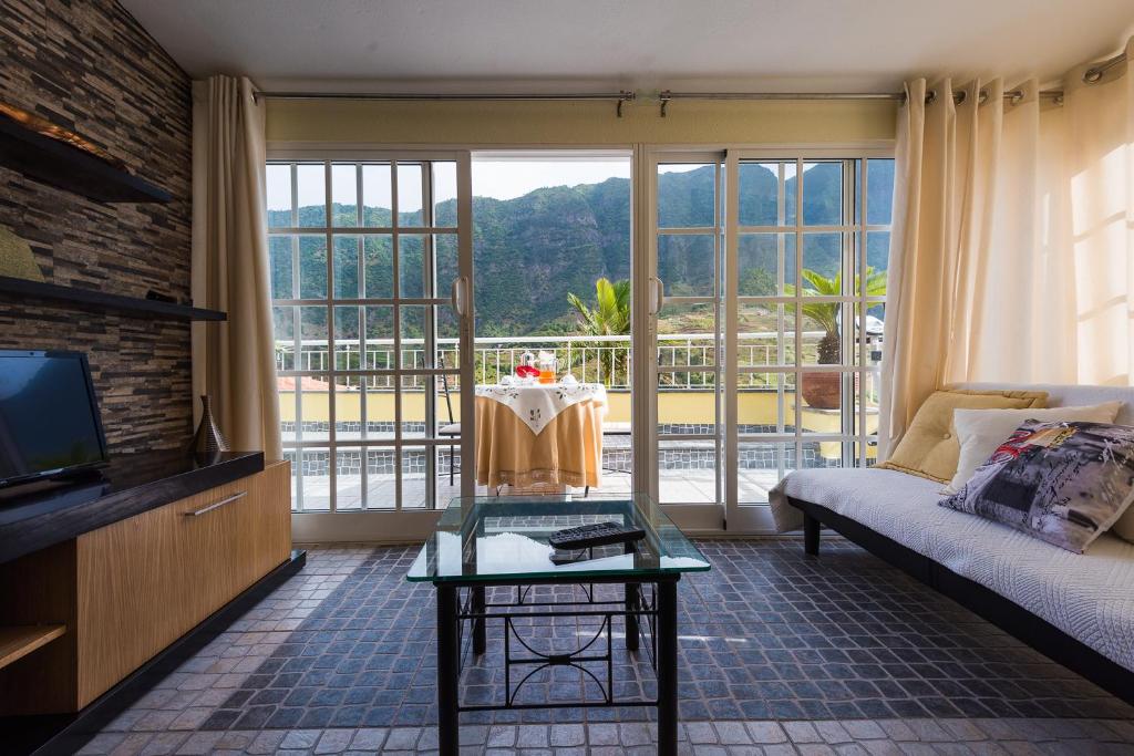 a living room with a couch and a tv at Terrace View House (Cantinho das Feiteiras) in São Vicente