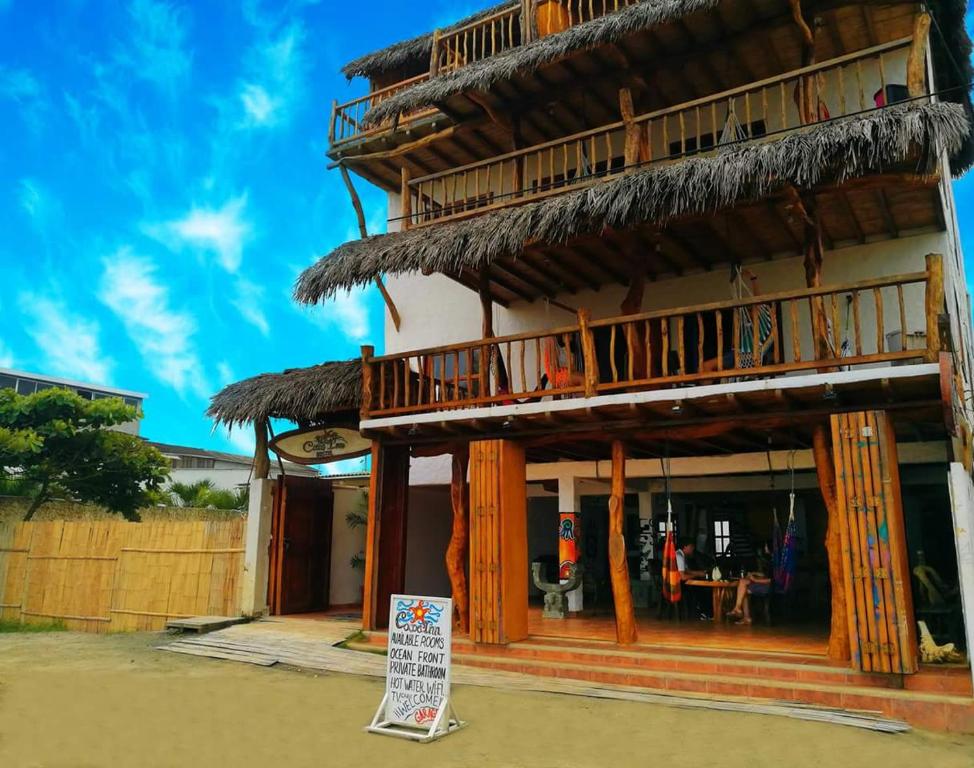 a building with a sign in front of it at Cocoa Inn Hostal in Canoa