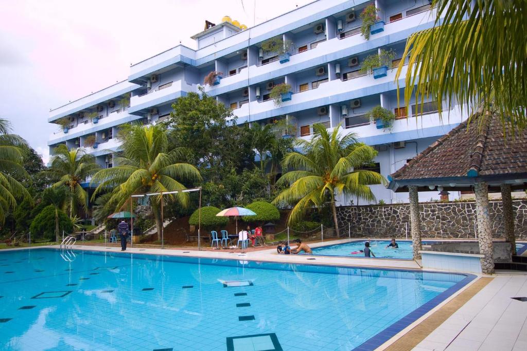 a large swimming pool in front of a hotel at Pelangi Hotel & Resort in Tanjung Pinang