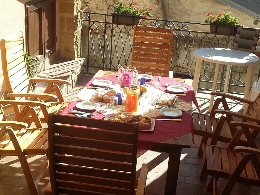 a table with food on it on a patio at b&b Caravella in Mezzojuso