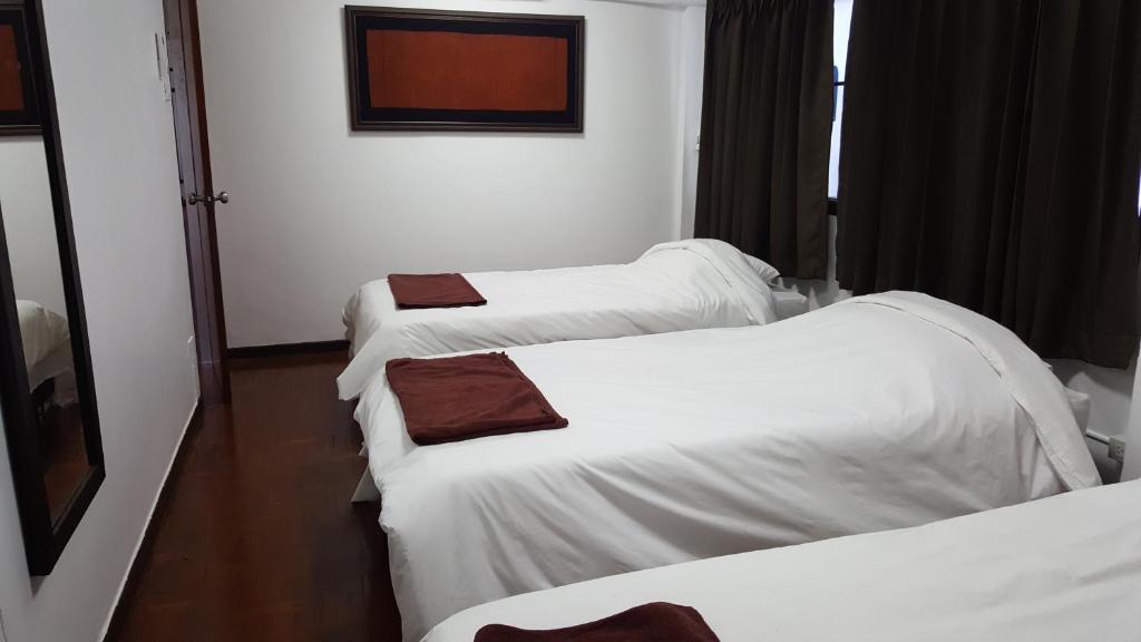 a group of three beds in a hotel room at Aunt & Uncle's House in Chiang Mai