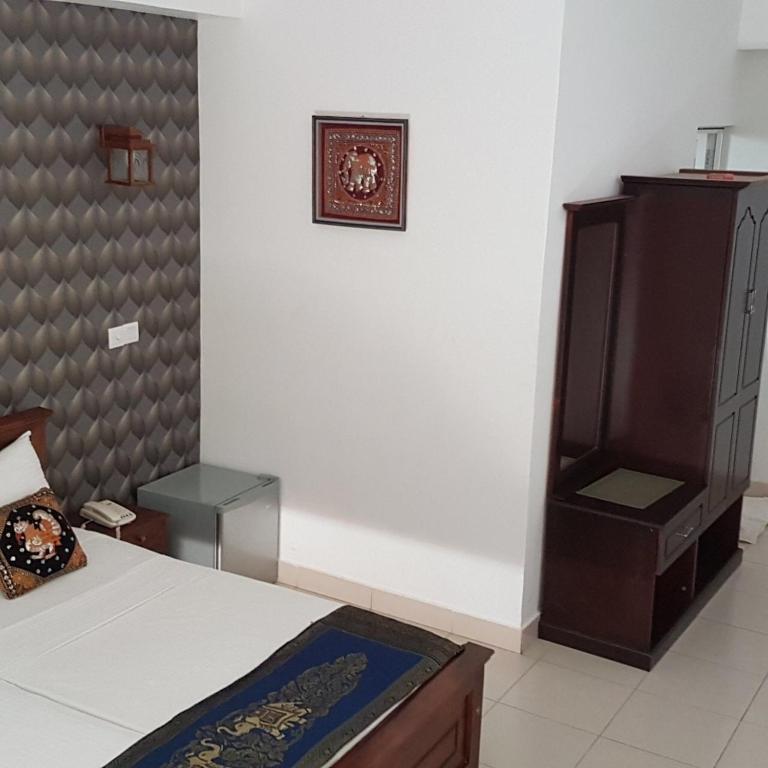 Postel nebo postele na pokoji v ubytování Kandy Supreme Hotel