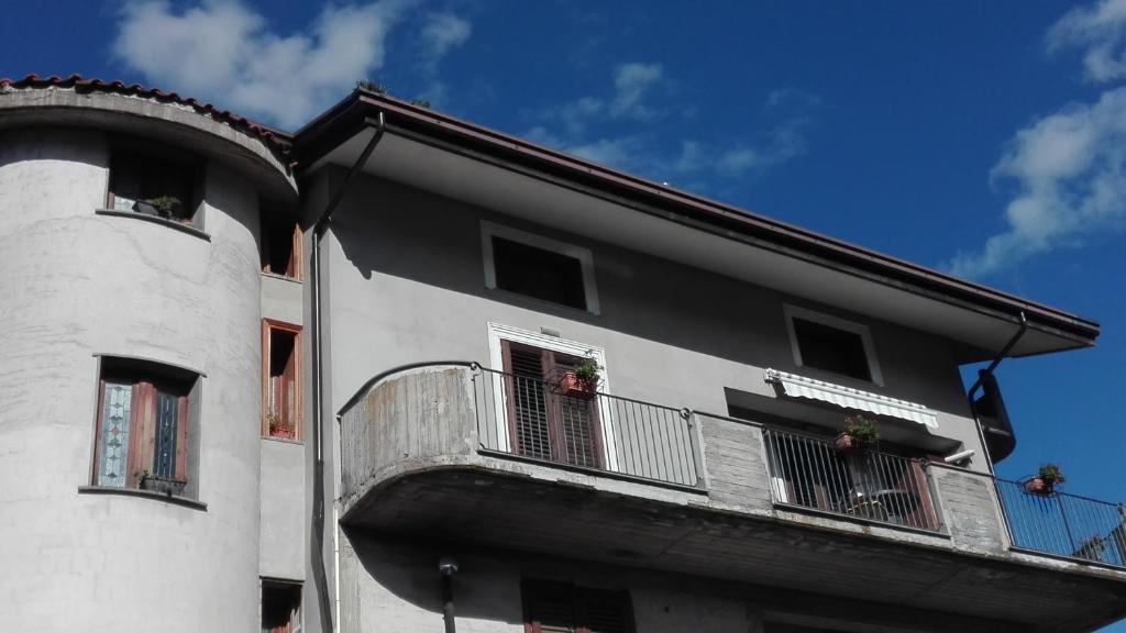 a white building with a balcony on the side of it at Il corbezzolo in Linguaglossa