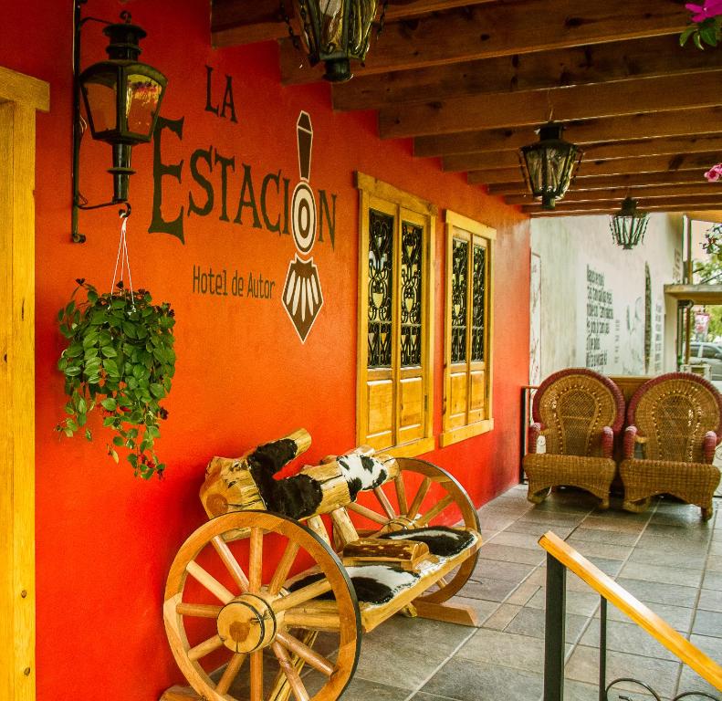 a wooden bench sitting in front of a building at Hotel La Estacion in Creel