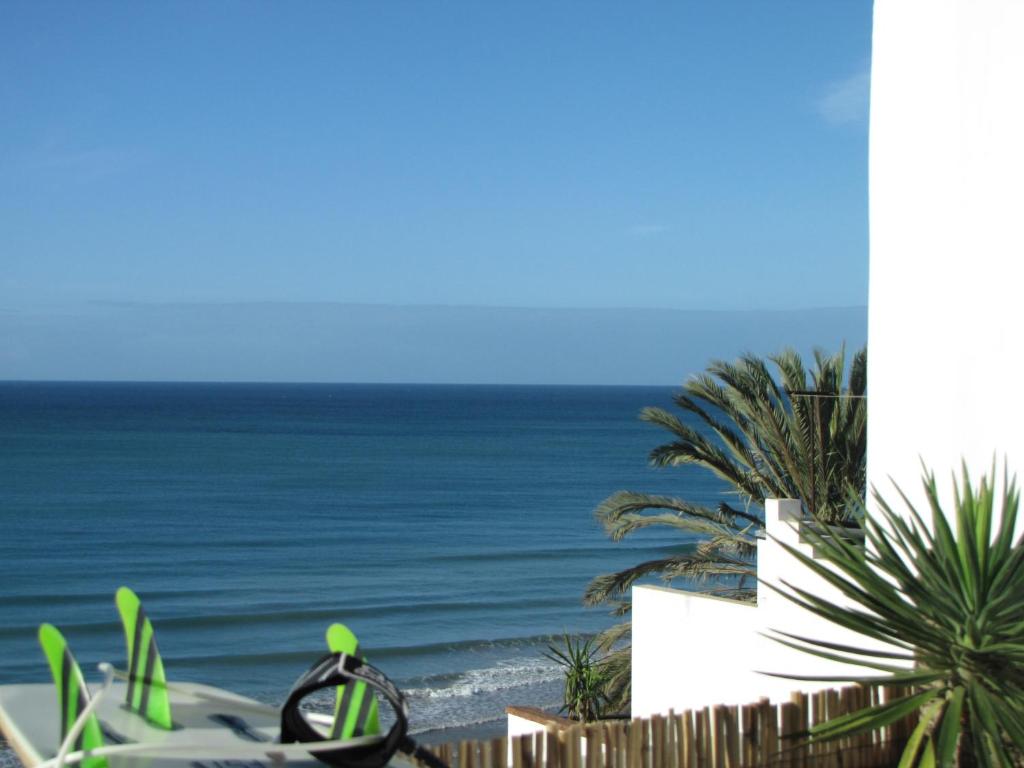 a view of the ocean from the balcony of a house at Surf & Travel Camp in Taghazout