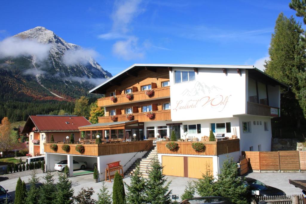 a hotel with a mountain in the background at Landhotel Wolf in Leutasch