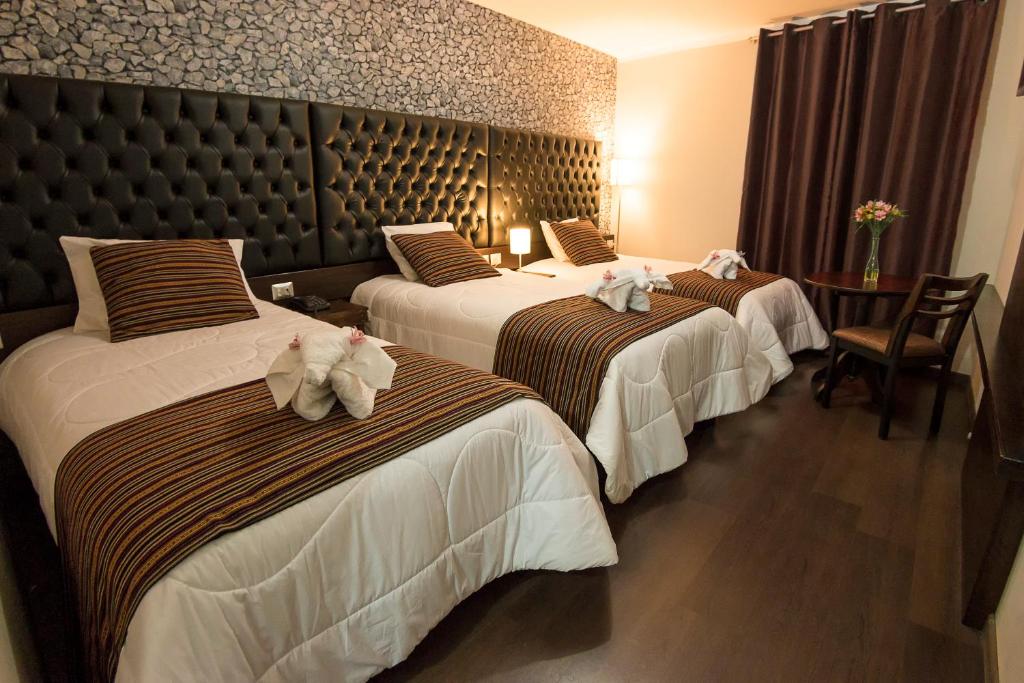 Katil atau katil-katil dalam bilik di Ureta Hotel