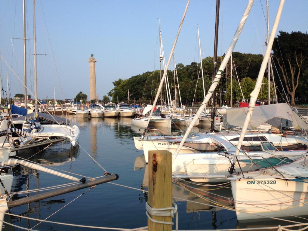 Un gruppo di barche ormeggiate in un porto turistico con un faro. di Ahoy Inn Guesthouse a Put-in-Bay