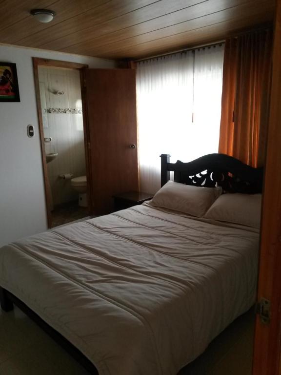 Postel nebo postele na pokoji v ubytování Hospedaje El Mirador