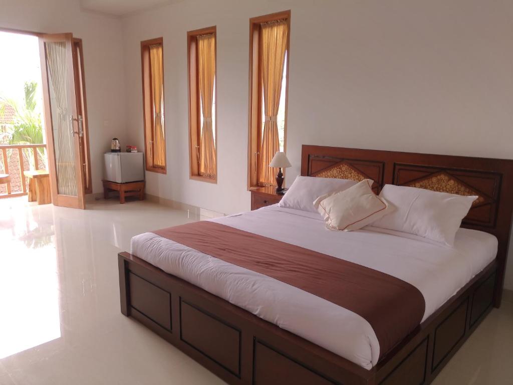 Postel nebo postele na pokoji v ubytování Mekenyem House Ubud