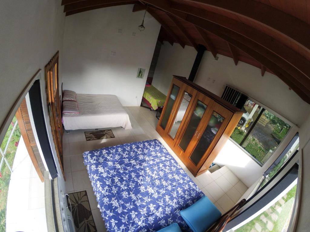 an aerial view of a bedroom with a bed and window at Sharing Home I in Três Coroas