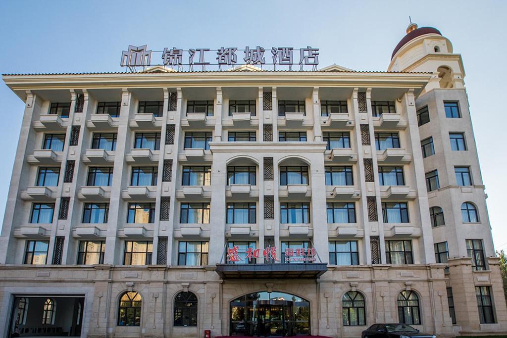 duży budynek z balkonem na górze w obiekcie Metropolo Jinjiang Shenyang Country Garden Datong Lake Subway Station w mieście Shenyang